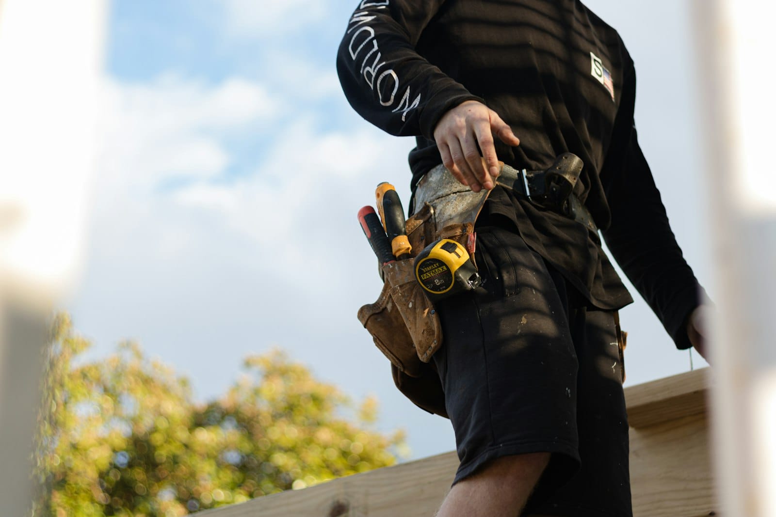 Tradie wearing a tool belt on a building site